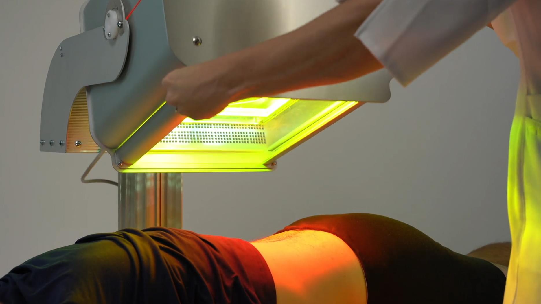 Photo of man receiving treatment on his feet with RX1 PBM model